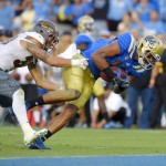 UCLA wide receiver Thomas Duarte, right, scores a touchdown as he breaks a tackle by Arizona State defensive back Jordan Simone during the first half of an NCAA college football game, Saturday, Oct. 3, 2015, in Pasadena, Calif. (AP Photo/Mark J. Terrill)