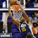 Utah Jazz's Derrick Favors (15) goes in for a reverse dunk against the Phoenix Suns as teammate Rudy Gobert, of France, watches during the first half of an NBA preseason basketball game Friday, Oct. 9, 2015, in Phoenix. (AP Photo/Ross D. Franklin)