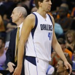 Dallas Mavericks' Dirk Nowitzki comes out of the game as head coach Rick Carlisle looks away during the first half of an NBA basketball game against the Phoenix Suns, Wednesday, Oct. 28, 2015, in Phoenix. (AP Photo/Matt York)