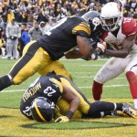 Pittsburgh Steelers outside linebacker James Harrison (92) blocks Arizona Cardinals wide receiver John Brown (12) after Pittsburgh Steelers free safety Mike Mitchell (23) intercepted a pass in the fourth quarter of an NFL football game, Sunday, Oct. 18, 2015, in Pittsburgh. Harrison was given an unnecessary roughness penalty on the play. (AP Photo/Don Wright)