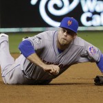 New York Mets' Lucas Duda can't handle a ball hit by Kansas City Royals' Ben Zobrist during the fourth inning of Game 2 of the Major League Baseball World Series Wednesday, Oct. 28, 2015, in Kansas City, Mo. (AP Photo/David J. Phillip)