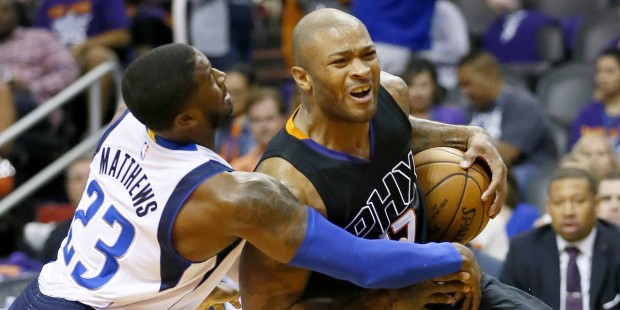 Phoenix Suns' P.J. Tucker is fouled by Dallas Mavericks' Wesley Matthews (23) during the second hal...