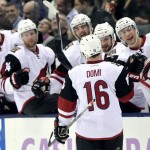 Arizona Coyotes' Max Domi (16) celebrates with teammates after scoring against the Toronto Maple Leafs during first period NHL hockey action in Toronto on Monday, Oct. 26, 2015. (Frank Gunn/The Canadian Press via AP)