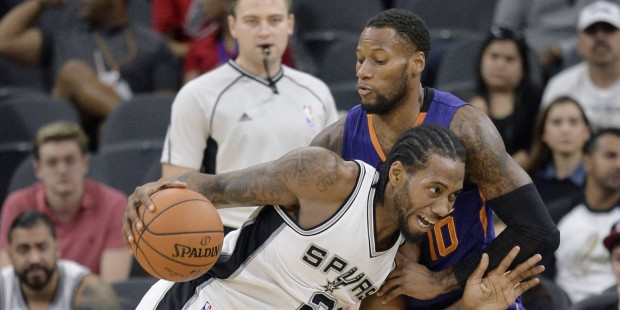 San Antonio Spurs forward Kawhi Leonard (2) drives against Phoenix Suns guard Sonny Weems during th...