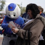 David Poesl looks at his tickets with his mom Susan Poesl before Game 4 of the Major League Baseball World Series between the New York Mets and Kansas City Royals Saturday, Oct. 31, 2015, in New York. (AP Photo/Julie Jacobson)