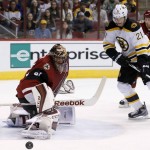 Boston Bruins' Loui Eriksson (21), of Sweden, gets his shot kicked away by Arizona Coyotes' Mike Smith, left, as Coyotes' Klas Dahlbeck (34), of Sweden, looks on during the first period of an NHL hockey game Saturday, Oct. 17, 2015, in Glendale, Ariz. (AP Photo/Ross D. Franklin)