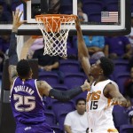 Sacramento Kings' Eric Moreland (25) scores as Phoenix Suns' Henry Sims (15) defends during the second half of an NBA preseason basketball game Wednesday, Oct. 7, 2015, in Phoenix. The Suns won 102-98. (AP Photo/Ross D. Franklin)