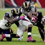 Arizona Cardinals running back David Johnson (31) his hit by St. Louis Rams outside linebacker Alec Ogletree (52) and safety Mark Barron (26) during the first half of an NFL football game, Sunday, Oct. 4, 2015, in Glendale, Ariz. (AP Photo/Ross D. Franklin)