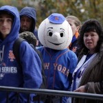 David Poesl with his mom Susan Poesl wait to get into Citi Field before Game 4 of the Major League Baseball World Series between the New York Mets and Kansas City Royals Saturday, Oct. 31, 2015, in New York. (AP Photo/Julie Jacobson)