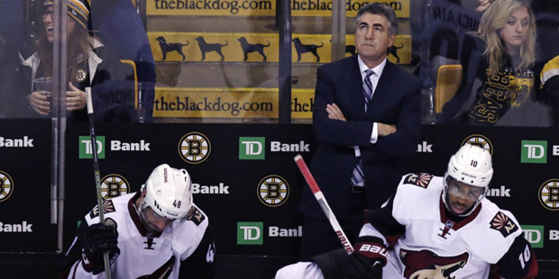 Arizona Coyotes head coach Dave Tippett looks up towards the scoreboard after Boston Bruins left wi...
