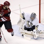 Pittsburgh Penguins' Marc-Andre Fleury (29) makes a save on a shot by Arizona Coyotes' Tobias Rieder (8), of Germany, during the first period of an NHL hockey game Saturday, Oct. 10, 2015, in Glendale, Ariz. (AP Photo/Ross D. Franklin)