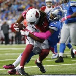 Arizona Cardinals wide receiver Larry Fitzgerald (11) is tackled by Detroit Lions cornerback Darius Slay (23) before falling into the end zone for a touchdown during the second half of an NFL football game, Sunday, Oct. 11, 2015, in Detroit. (AP Photo/Rick Osentoski)