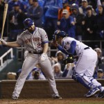 Kansas City Royals catcher Salvador Perez goes back to the dug out after New York Mets' Daniel Murphy struck out looking during the sixth inning of Game 2 of the Major League Baseball World Series Wednesday, Oct. 28, 2015, in Kansas City, Mo. (AP Photo/Matt Slocum)