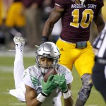 Oregon's Darren Carrington, left, makes a diving catch as he gets past Arizona State's Kweishi Brown (10) during the first half of an NCAA college football game Thursday, Oct. 29, 2015, in Tempe, Ariz. (AP Photo/Ross D. Franklin)