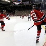 In a photograph taken with a fisheye lens, New Jersey Devils center Travis Zajac, right, and teammate center Jacob Josefson, of Sweden, celebrate Zajac's goal after scoring a goal against the Arizona Coyotes during the second period of an NHL hockey game, Tuesday, Oct. 20, 2015, in Newark, N.J. (AP Photo/Julio Cortez)