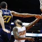 Phoenix Suns' Markieff Morris, right, gets past Utah Jazz's Rudy Gobert (27), of France, for a basket during the first half of an NBA preseason basketball game Friday, Oct. 9, 2015, in Phoenix. (AP Photo/Ross D. Franklin)