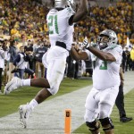 Oregon's Royce Freeman (21) celebrates his touchdown run against Arizona State with Tyrell Crosby (73) during the first half of an NCAA college football game Thursday, Oct. 29, 2015, in Tempe, Ariz. (AP Photo/Ross D. Franklin)