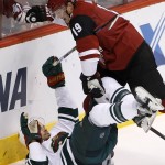 Arizona Coyotes' Shane Doan (19) checks Minnesota Wild's Nate Prosser to the ice during the second period of an NHL hockey game Thursday, Oct. 15, 2015, in Glendale, Ariz. The Wild won 4-3. (AP Photo/Ross D. Franklin)
