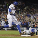 New York Mets' Curtis Granderson is safe at first as Kansas City Royals' Eric Hosmer can't touch the bag during the fifth inning of Game 4 of the Major League Baseball World Series Saturday, Oct. 31, 2015, in New York. (AP Photo/David J. Phillip)