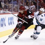 Arizona Coyotes defenseman Zbynek Michalek (4) shields San Jose Sharks right wing Mike Brown from the puck in the first period during a preseason NHL hockey game, Friday, Oct. 2, 2015, in Glendale, Ariz. (AP Photo/Rick Scuteri)