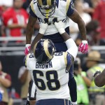 St. Louis Rams offensive guard Jamon Brown (68) lifts wide receiver Tavon Austin (11) after Austin scored a touchdown against the Arizona Cardinals during the first half of an NFL football game, Sunday, Oct. 4, 2015, in Glendale, Ariz. (AP Photo/Ross D. Franklin)
