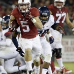 Stanford's Christian McCaffrey (5) runs past Arizona safety Anthony Lopez (28) during the second half of an NCAA college football game Saturday, Oct. 3, 2015, in Stanford, Calif.  (AP Photo/Marcio Jose Sanchez)
