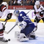 Toronto Maple Leafs goaltender James Reimer, centre, makes a save against Arizona Coyotes' Oliver Ekman-Larsson, left, as Coyotes' Mikkel Boedker (89) looks on during third period NHL hockey action in Toronto on Monday, Oct. 26, 2015. (Frank Gunn/The Canadian Press via AP)