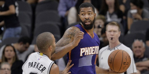 Phoenix Suns forward Markieff Morris, right, looks to pass around San Antonio Spurs guard Tony Park...