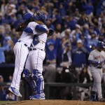 Kansas City Royals catcher Salvador Perez, right, hugs starting pitcher Johnny Cueto at the end of Game 2 of the Major League Baseball World Series against the New York Mets Wednesday, Oct. 28, 2015, in Kansas City, Mo. The Royals defeated the Mets 7-1 to take at two game lead in the series.  (AP Photo/Matt Slocum)