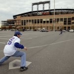 Chris Hubbard, left, plays catch with his son Luke at the site of the old Shea Stadium home plate before Game 4 of the Major League Baseball World Series between the Kansas City Royals and the New York Mets Saturday, Oct. 31, 2015, in New York. (AP Photo/Julie Jacobson)