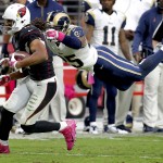 Arizona Cardinals wide receiver Larry Fitzgerald (11) makes the catch as St. Louis Rams strong safety T.J. McDonald (25) defends during the second half of an NFL football game, Sunday, Oct. 4, 2015, in Glendale, Ariz. (AP Photo/Rick Scuteri)