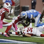 Detroit Lions running back Theo Riddick (25) falls into the end zone for a touchdown during the first half of an NFL football game against the Arizona Cardinals, Sunday, Oct. 11, 2015, in Detroit. (AP Photo/Duane Burleson)