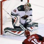 Arizona Coyotes' Anthony Duclair (10) scores a goal against Minnesota Wild's Devan Dubnyk (40) during the second period of an NHL hockey game Thursday, Oct. 15, 2015, in Glendale, Ariz. (AP Photo/Ross D. Franklin)
