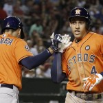 Houston Astros' George Springer (4) celebrates his home run against the Arizona Diamondbacks with Carlos Correa (1) during the second inning of a baseball game Friday, Oct. 2, 2015, in Phoenix. (AP Photo/Ross D. Franklin)