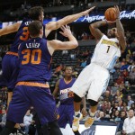 Denver Nuggets guard Jameer Nelson, right, fades back for a shot as Phoenix Suns forward Mirza Teletovic, back left, and forward Jon Leuer defend during the second half of an NBA basketball game Friday, Oct. 16, 2015, in Denver. The Nuggets won 106-81. (AP Photo/David Zalubowski)
