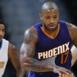Phoenix Suns forward P.J. Tucker, front, picks up a loose ball in front of Denver Nuggets guard Gary Harris, back left, and Suns center Alex Len in the first half of an NBA preseason basketball game Friday, Oct. 16, 2015, in Denver. (AP Photo/David Zalubowski)