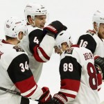 Arizona Coyotes' Mikkel Boedker (89) celebrates his second goal of the game with teammates Klas Dahlbeck (34) Zbynek Michalek (4) and Max Domi (16) during the thirds period of an NHL hockey game against the Ottawa Senators, Saturday, Oct. 24, 2015, in Ottawa, Ontario. (Fred Chartrand /The Canadian Press via AP) MANDATORY CREDIT