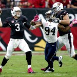 Arizona Cardinals quarterback Carson Palmer (3) throws under pressure from St. Louis Rams defensive end Robert Quinn (94)  during the first half of an NFL football game, Sunday, Oct. 4, 2015, in Glendale, Ariz. (AP Photo/Ross D. Franklin)