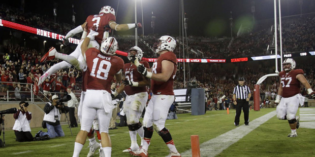 Stanford's Michael Rector, top left, is lifted by teammates after a touchdown catch against Arizona...