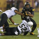 Arizona State running back Demario Richard (4) is hit by Colorado defensive lineman Leo Jackson III (52) during the first half of an NCAA college football game, Saturday, Oct. 10, 2015, in Tempe, Ariz. Richared fumbled the ball on the play and Arizona State recovered for a touchdown. (AP Photo/Matt York)