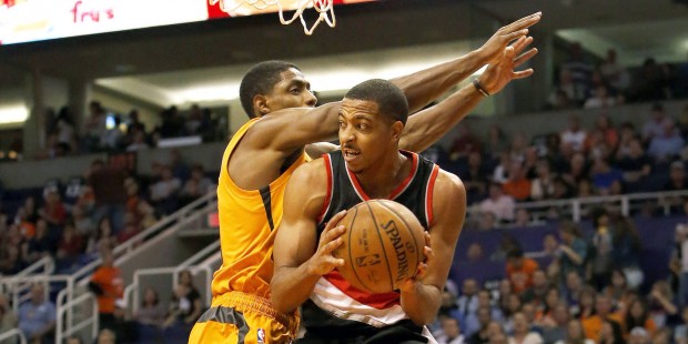 Portland Trail Blazers guard C.J. McCollum, right, drives on Phoenix Suns guard Brandon Knight in t...