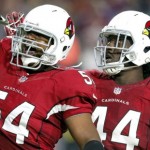 Arizona Cardinals linebacker Dwight Freeney (54) salutes the fans with teammate Markus Golden (44) after his sack in Baltimore Ravens quarterback Joe Flacco during the second half of an NFL football game, Monday, Oct. 26, 2015, in Glendale, Ariz. (AP Photo/Rick Scuteri)