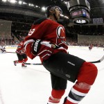 In a photograph taken with a fisheye lens, New Jersey Devils center Travis Zajac celebrates after scoring a goal against the Arizona Coyotes during the second period of an NHL hockey game, Tuesday, Oct. 20, 2015, in Newark, N.J. (AP Photo/Julio Cortez)