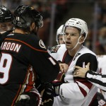 An official pulls Arizona Coyotes' Zbynek Michalek, right, away from Anaheim Ducks' Patrick Maroon (19) during the second period of an NHL hockey game in Anaheim, Calif., Wednesday, Oct. 14, 2015. (AP Photo/Christine Cotter)