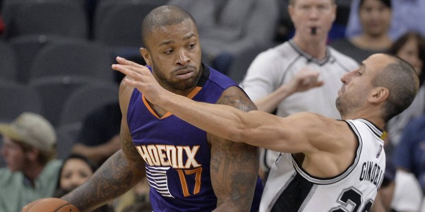 Phoenix Suns forward P.J. Tucker (17) knocks down San Antonio Spurs guard Manu Ginobili, of Argenti...