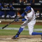 New York Mets' Curtis Granderson hits an RBI sacrifice fly to score Wilmer Flores during the third inning of Game 4 of the Major League Baseball World against the Kansas City Royals Series Saturday, Oct. 31, 2015, in New York. (AP Photo/Matt Slocum)