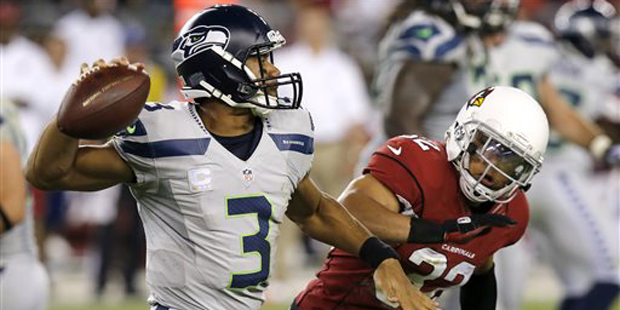 Seattle Seahawks quarterback Russell Wilson (3) scrambles as Arizona Cardinals free safety Tyrann M...