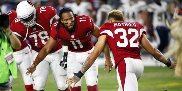 Arizona Cardinals wide receiver Larry Fitzgerald (11) greets teammate Tyrann Mathieu (32) prior to ...