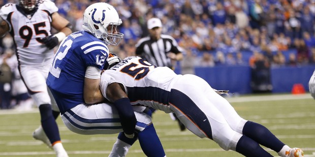 Indianapolis Colts' Andrew Luck (12) is tackled by Denver Broncos' Danny Trevathan (59) during the ...