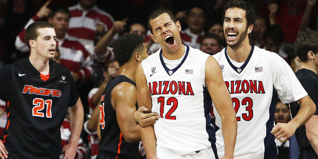 Arizona forward Ryan Anderson (12) reacts with Mark Tollefsen after scoring during the first half o...